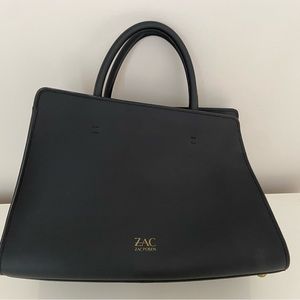 Medium size tote. Great condition comes with dust bag.